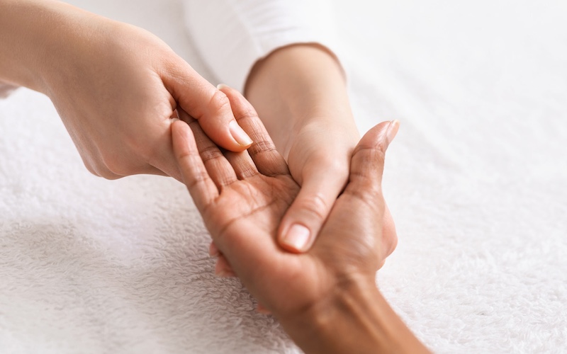Top view of african woman getting hand massage at spa Pre-made facials for face, feet, or hands in Brampton, designed to rejuvenate and refresh your skin